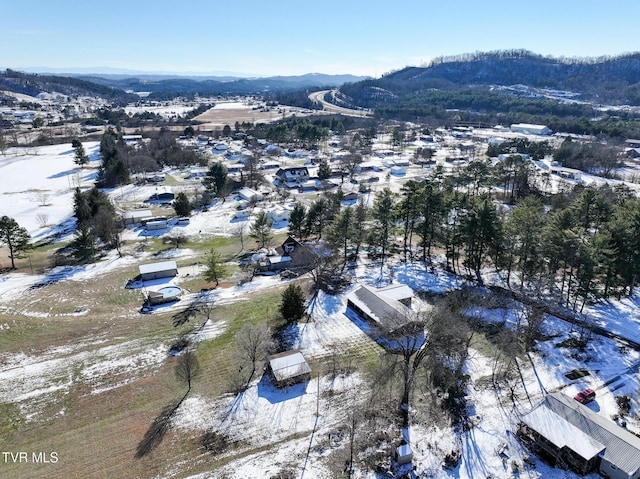 snowy aerial view with a mountain view