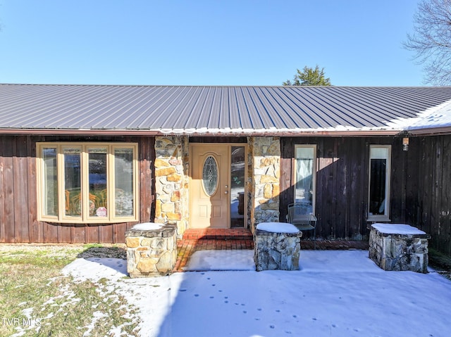 view of snow covered property entrance