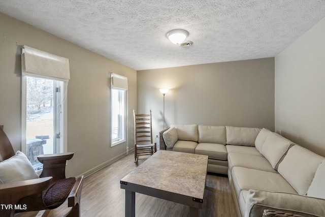 living room featuring a textured ceiling and hardwood / wood-style floors