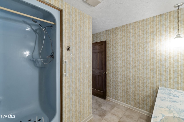 bathroom with a shower and a textured ceiling