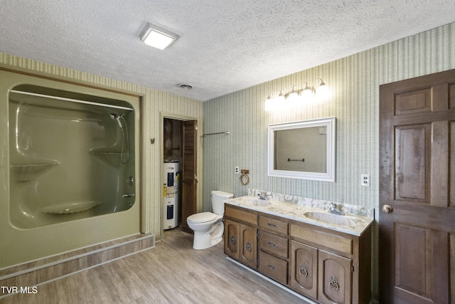 bathroom featuring a shower, hardwood / wood-style floors, electric water heater, a textured ceiling, and vanity