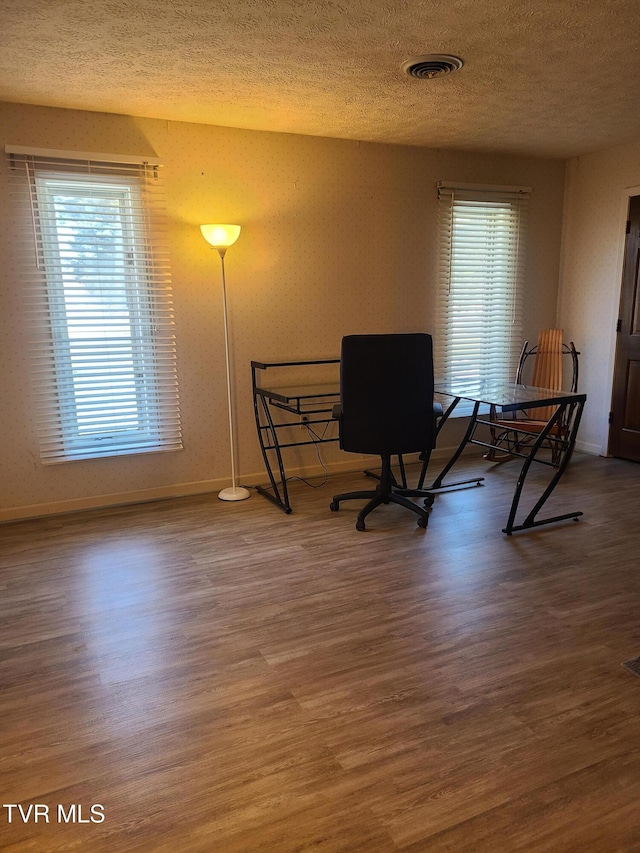 office with a textured ceiling and hardwood / wood-style floors