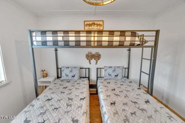 bedroom featuring crown molding and parquet floors