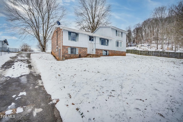 view of snow covered back of property