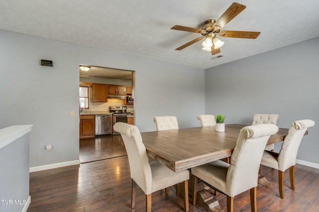 dining room with ceiling fan, dark wood-type flooring, sink, and a textured ceiling