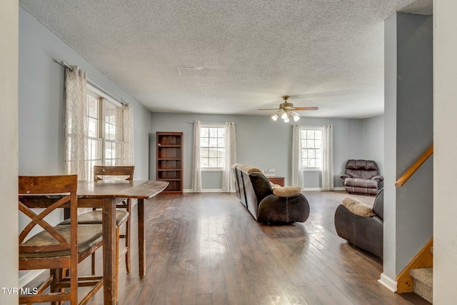 living room with ceiling fan, hardwood / wood-style floors, and a textured ceiling