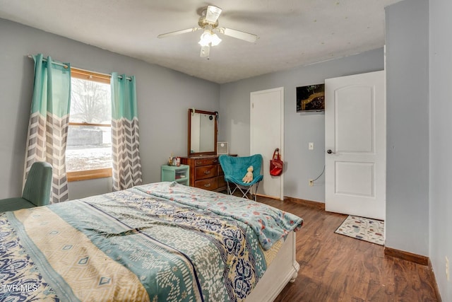 bedroom with ceiling fan and dark hardwood / wood-style flooring