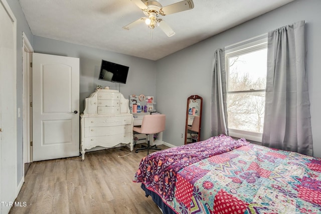 bedroom with ceiling fan and light wood-type flooring