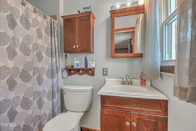 bathroom featuring toilet and vanity