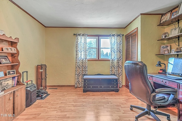 office space featuring a textured ceiling, crown molding, and light hardwood / wood-style flooring