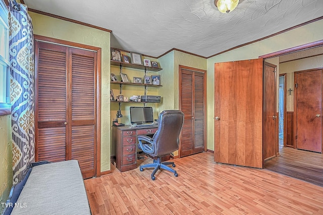 home office featuring a textured ceiling, crown molding, and light hardwood / wood-style floors