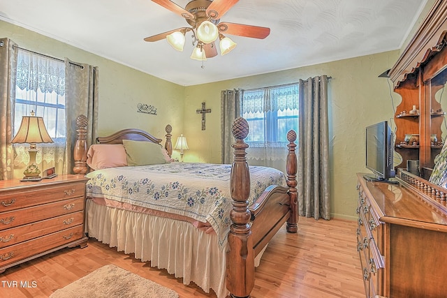 bedroom with ceiling fan and light hardwood / wood-style floors