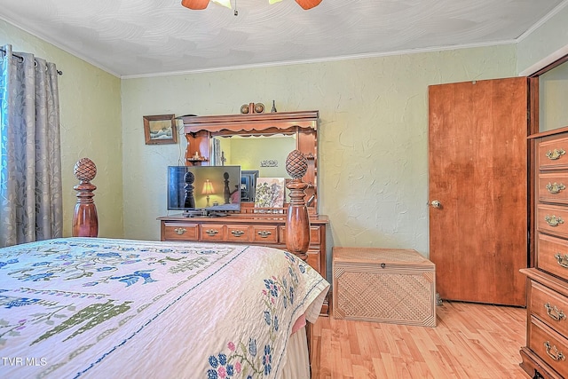 bedroom with ceiling fan, ornamental molding, and light wood-type flooring