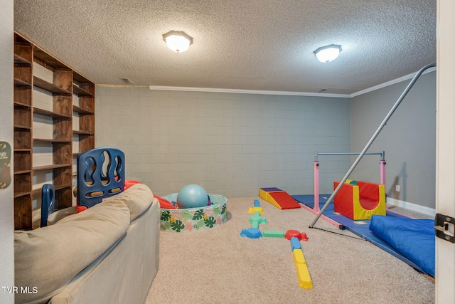 rec room with a textured ceiling, carpet, and crown molding