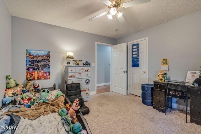 bedroom featuring ceiling fan, a textured ceiling, and light carpet