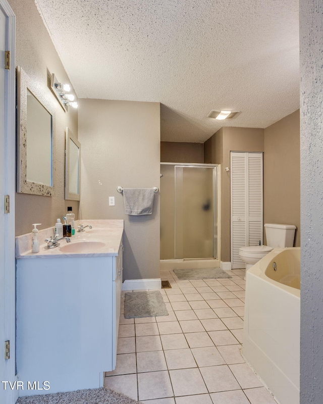 bathroom with a textured ceiling, tile patterned flooring, vanity, toilet, and a shower with shower door