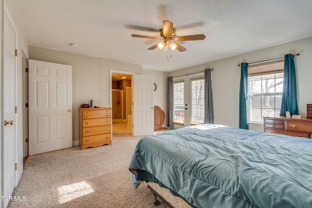 carpeted bedroom with ceiling fan, access to exterior, french doors, and a textured ceiling