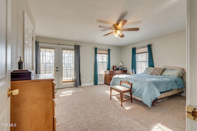 bedroom featuring ceiling fan, access to outside, light colored carpet, french doors, and a textured ceiling