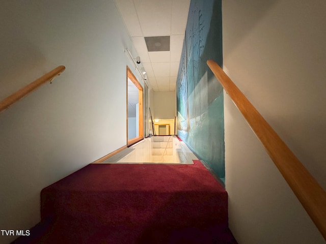 stairs featuring a paneled ceiling