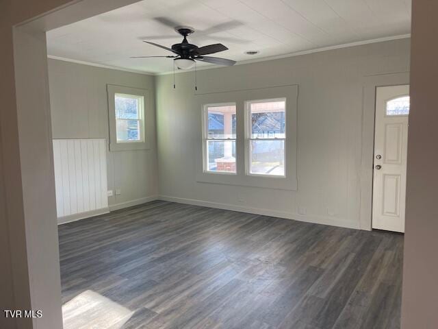 spare room with ceiling fan, dark wood-type flooring, and crown molding