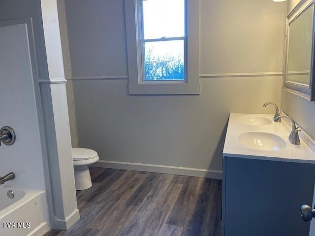 full bathroom featuring tub / shower combination, wood-type flooring, toilet, and vanity