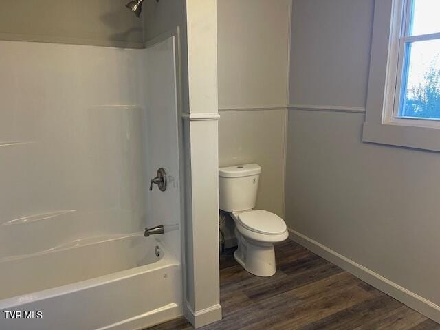 bathroom featuring toilet, shower / bath combination, and wood-type flooring