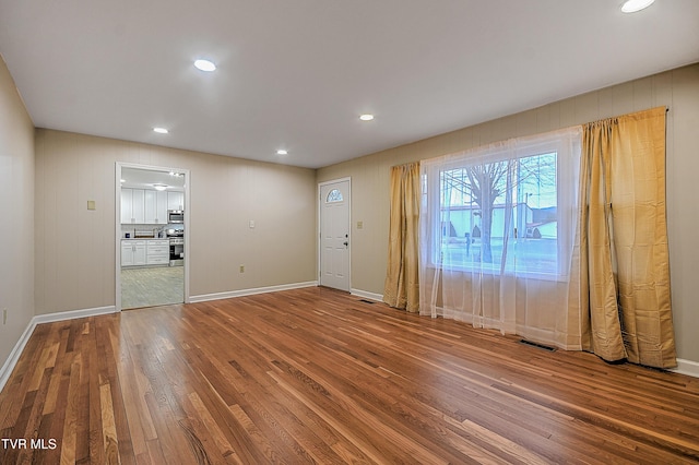 unfurnished room with wood-type flooring