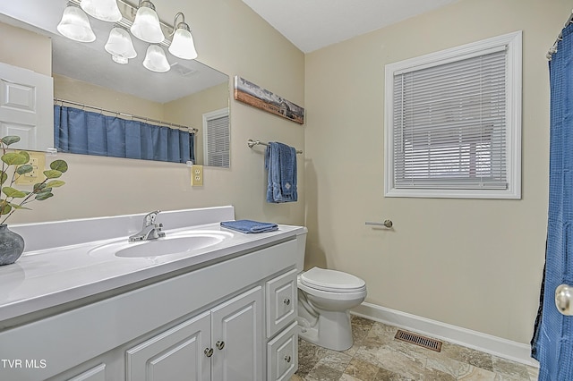 bathroom featuring vanity and toilet