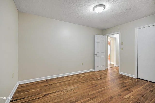 unfurnished bedroom with a textured ceiling and hardwood / wood-style floors