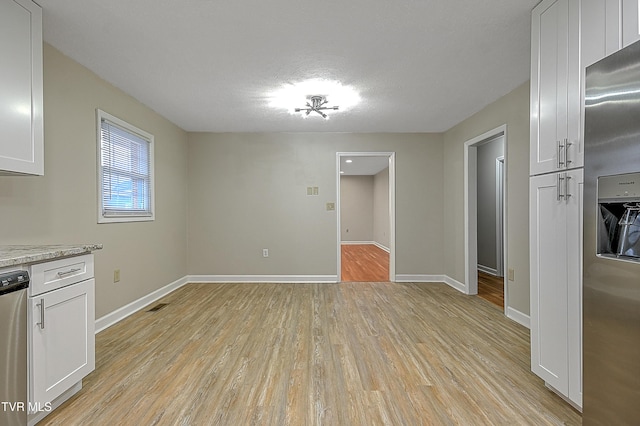 unfurnished dining area featuring light hardwood / wood-style floors