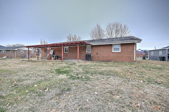 back of house with a patio, a yard, and central AC unit