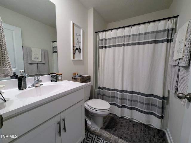 bathroom featuring toilet, vanity, and tile patterned floors