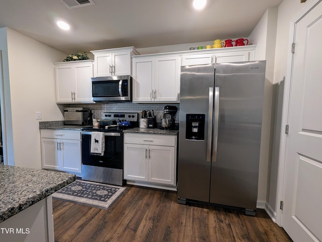 kitchen featuring dark wood-type flooring, stainless steel appliances, and white cabinetry