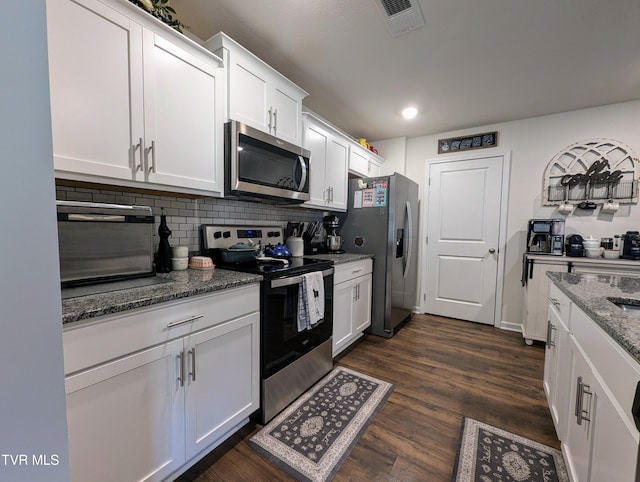 kitchen featuring backsplash, appliances with stainless steel finishes, stone countertops, and white cabinetry