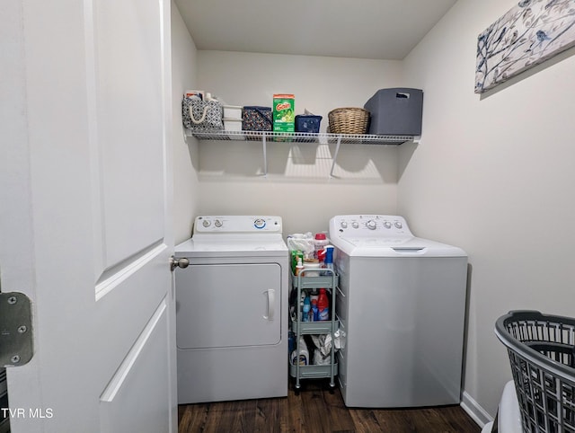 clothes washing area with dark wood-type flooring and washer and dryer