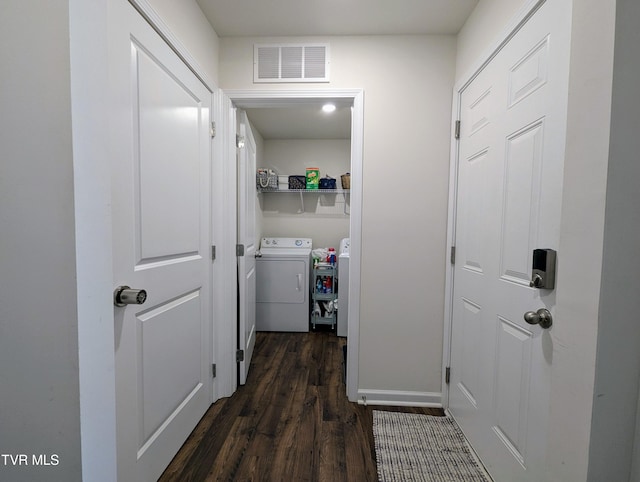 corridor with dark hardwood / wood-style flooring and independent washer and dryer