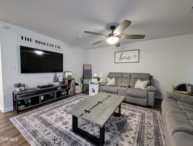 living room with ceiling fan and dark hardwood / wood-style flooring