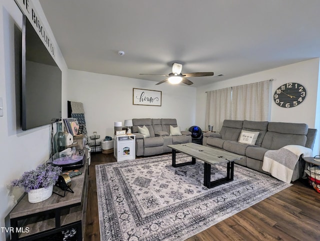 living room with dark wood-type flooring and ceiling fan