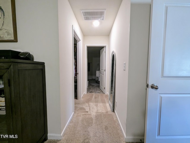 corridor with light colored carpet