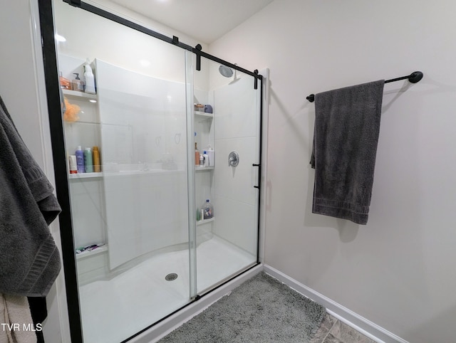 bathroom featuring a shower with door