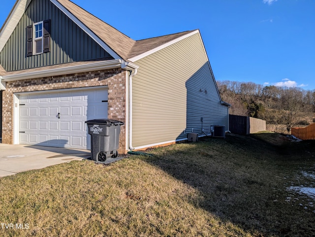 view of home's exterior with central AC unit, a garage, and a lawn