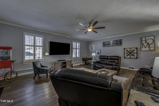 living room featuring a textured ceiling, dark wood-type flooring, and ornamental molding