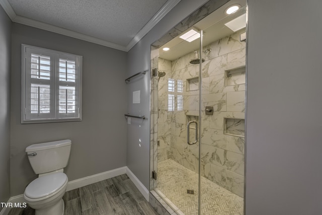 bathroom featuring toilet, an enclosed shower, a textured ceiling, and crown molding