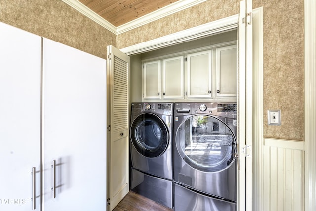 laundry area with cabinets, wooden ceiling, crown molding, dark hardwood / wood-style floors, and washing machine and clothes dryer