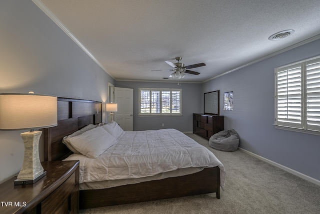 carpeted bedroom featuring ceiling fan and crown molding