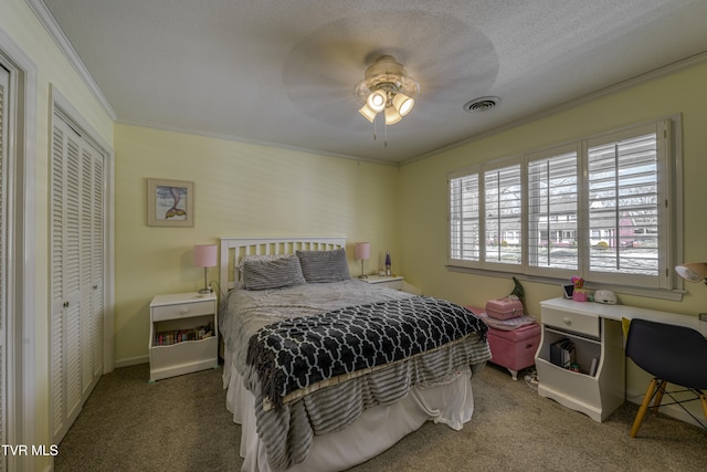 bedroom with ornamental molding, carpet floors, ceiling fan, and a closet