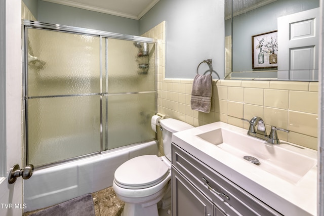 full bathroom with shower / bath combination with glass door, tile walls, backsplash, vanity, and crown molding