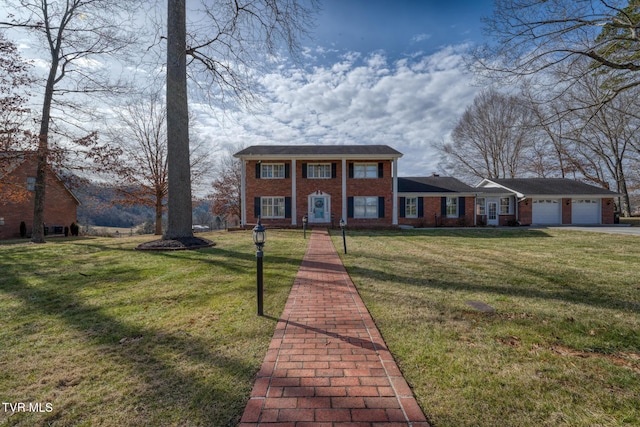 view of front of property with a garage and a front lawn