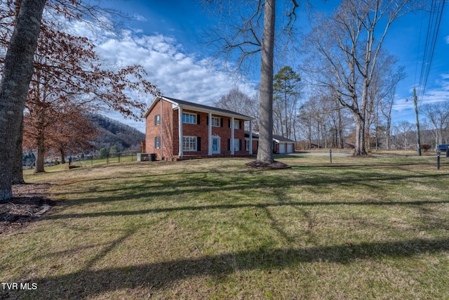 204 Amity Dr, Bristol, TN 37620 - colonial-style house featuring cooling unit, fence, a front lawn, brick siding, and a mountain view