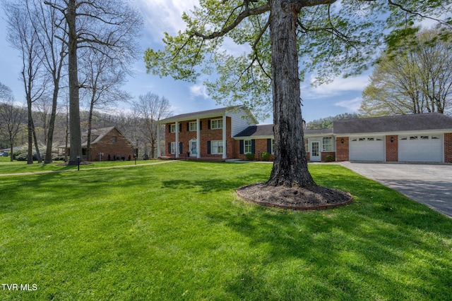 204 Amity Dr, Bristol, TN 37620 - neoclassical / greek revival house featuring a garage, brick siding, driveway, and a front lawn